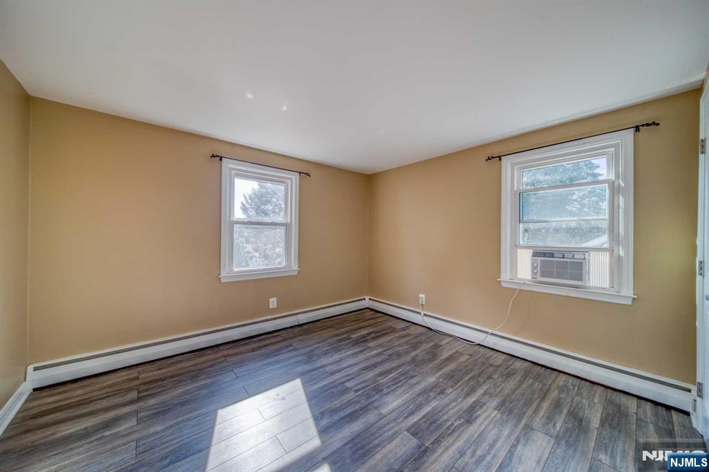 202 Stone Street Maywood, NJ 07607 - Photo 9 of 11 a view of an empty room with wooden floor and a window