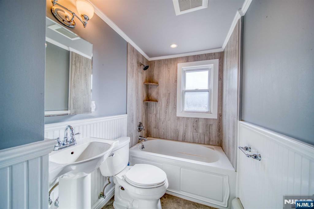 202 Stone Street Maywood, NJ 07607 - Photo 10 of 11 a bathroom with a sink toilet bathtub and vanity
