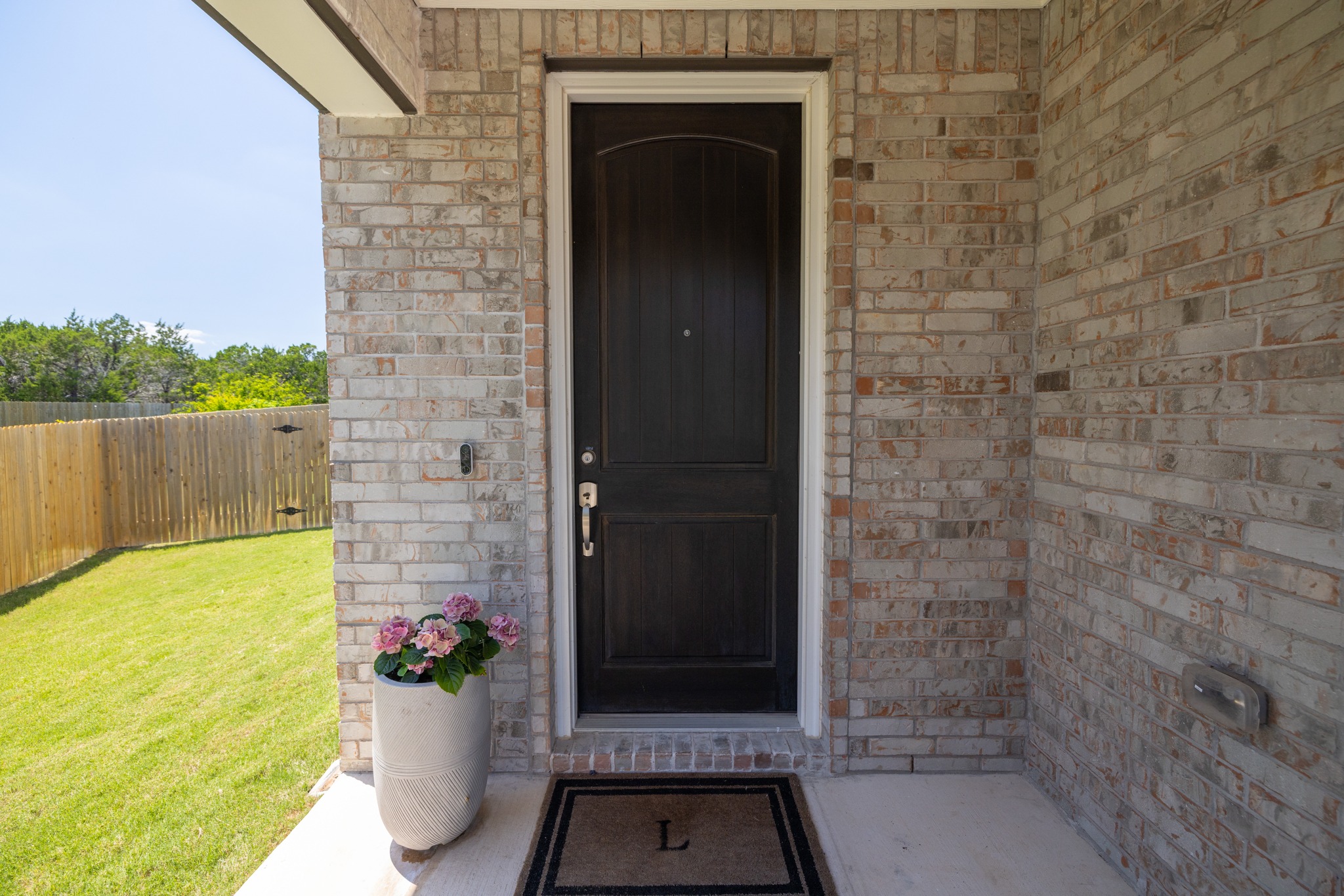 2049 Winston Way Leander, TX 78641 - Photo 2 of 35 A charming covered front porch and impressive 8' solid mahogany front door welcomes guests.