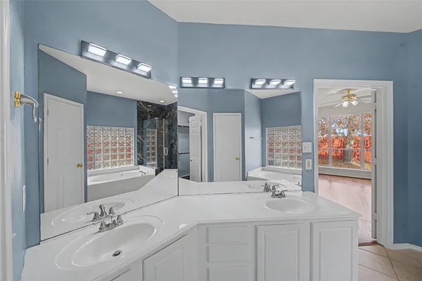 a bathroom with a double vanity sink and a mirror