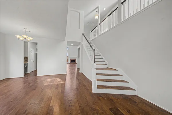 a view of entryway and hall with wooden floor