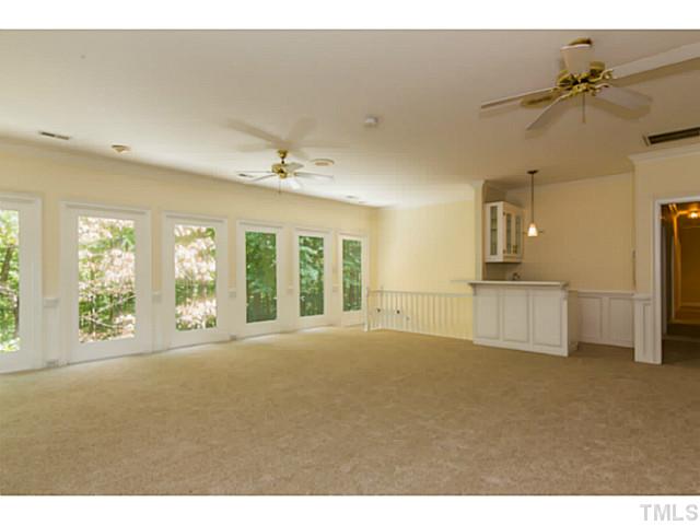 1300 Milvaney Court Raleigh, NC 27615 - Photo 11 of 25 The library/great room and wet bar overlook a private forested lot.