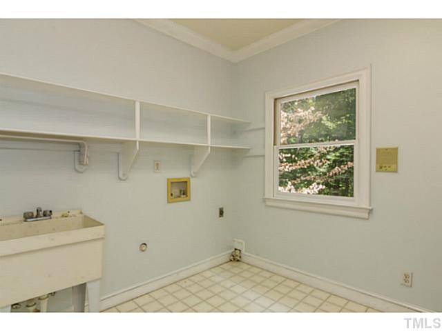 1300 Milvaney Court Raleigh, NC 27615 - Photo 19 of 25 Big laundry room with storage and natural light.