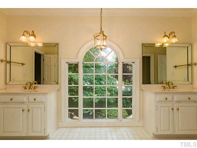 1300 Milvaney Court Raleigh, NC 27615 - Photo 20 of 25 Guest suite bathroom with dual bowl vanities, chandelier and 30 light window.