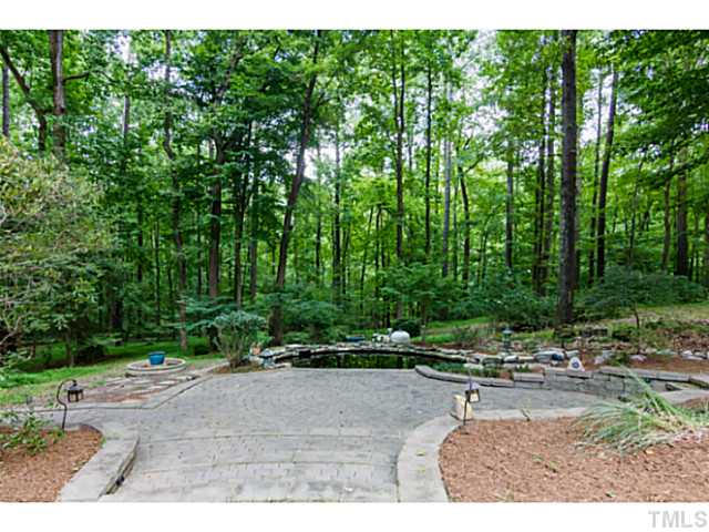 1300 Milvaney Court Raleigh, NC 27615 - Photo 23 of 25 Koi pond with stone surround for peaceful reflections or summer night parties.