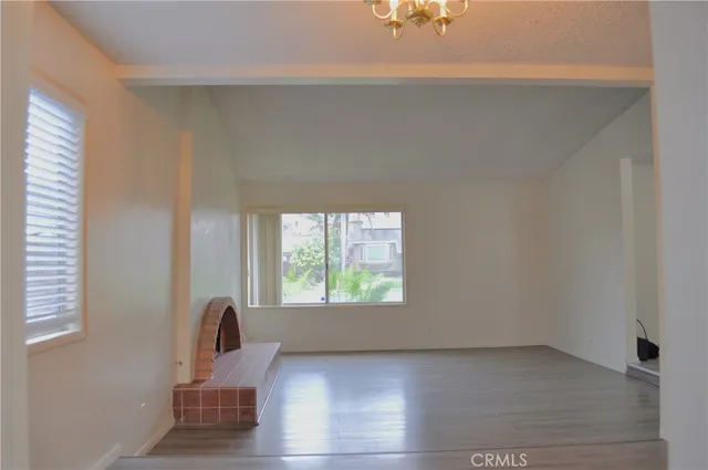 a view of kitchen with cabinets and refrigerator