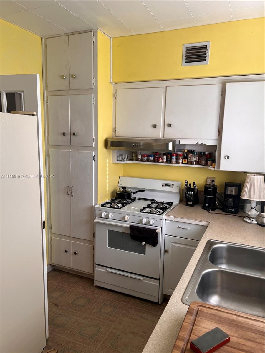 4475 Kirk Road Lake Worth, FL 33461 - Photo 12 of 26 a kitchen with stainless steel appliances granite countertop a sink and a refrigerator