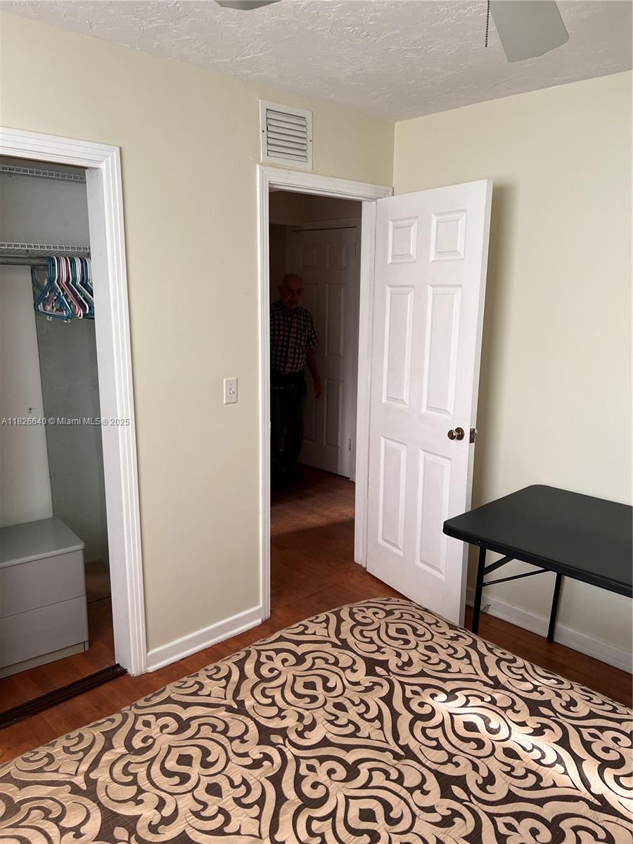 4475 Kirk Road Lake Worth, FL 33461 - Photo 17 of 26 a view of a bedroom with wooden floor and closet