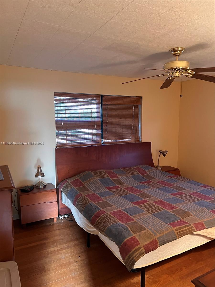 4475 Kirk Road Lake Worth, FL 33461 - Photo 20 of 26 a bedroom with a bed and wooden floor