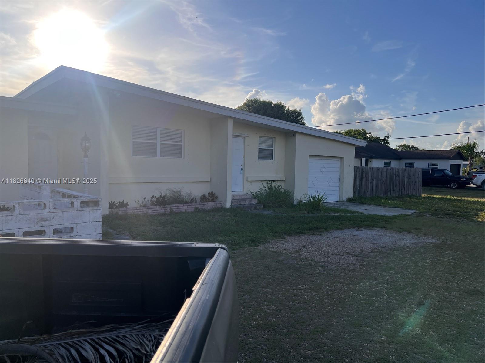 4475 Kirk Road Lake Worth, FL 33461 - Photo 6 of 26 a back view of house with yard and outdoor seating