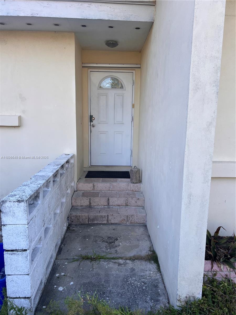 4475 Kirk Road Lake Worth, FL 33461 - Photo 8 of 26 a view of a hallway with wooden walls and stairs