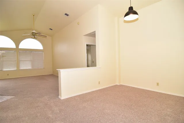 a view of a room with window and ceiling fan