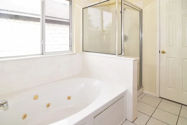 a bathroom with a bathtub and a shower