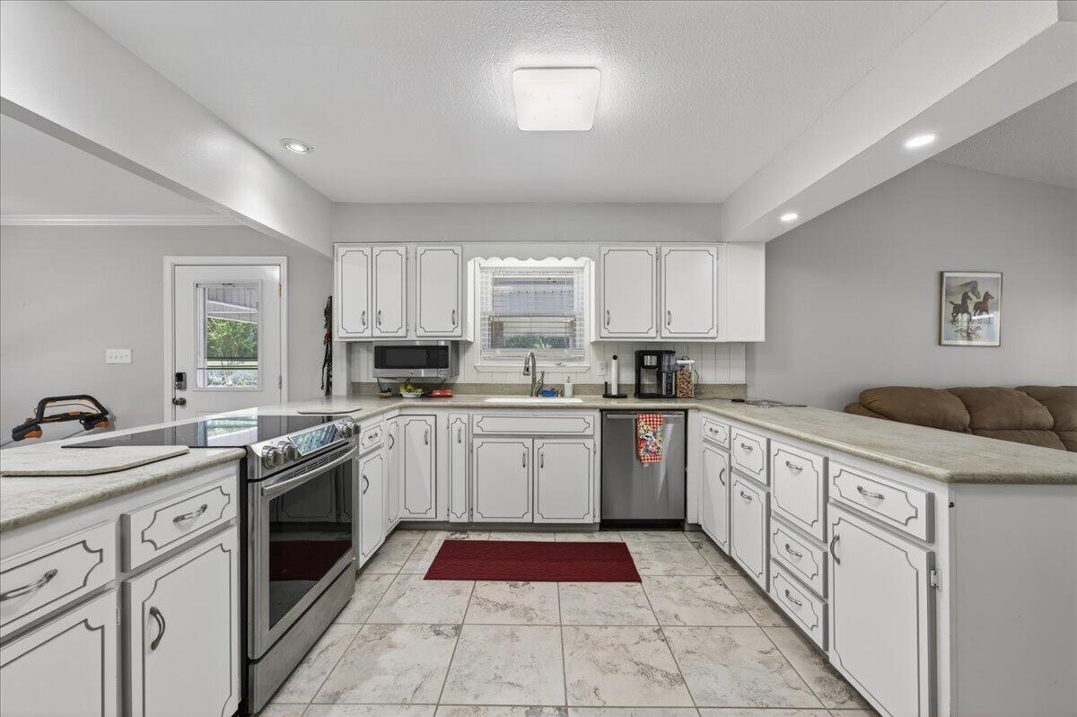 210 Shell Drive Crestview, FL 32536 - Photo 9 of 67 a kitchen with a sink stove top oven and cabinets