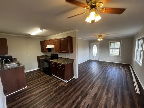 a kitchen with wooden floors and a fireplace
