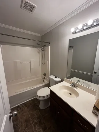 a bathroom with a sink a toilet a mirror and shower