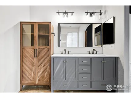 a spacious bathroom with a sink double vanity and mirror