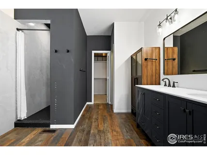 a bathroom with a sink a mirror and a shower