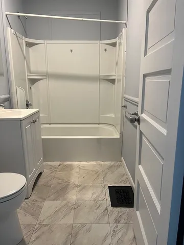 a bathroom with a toilet and a shower