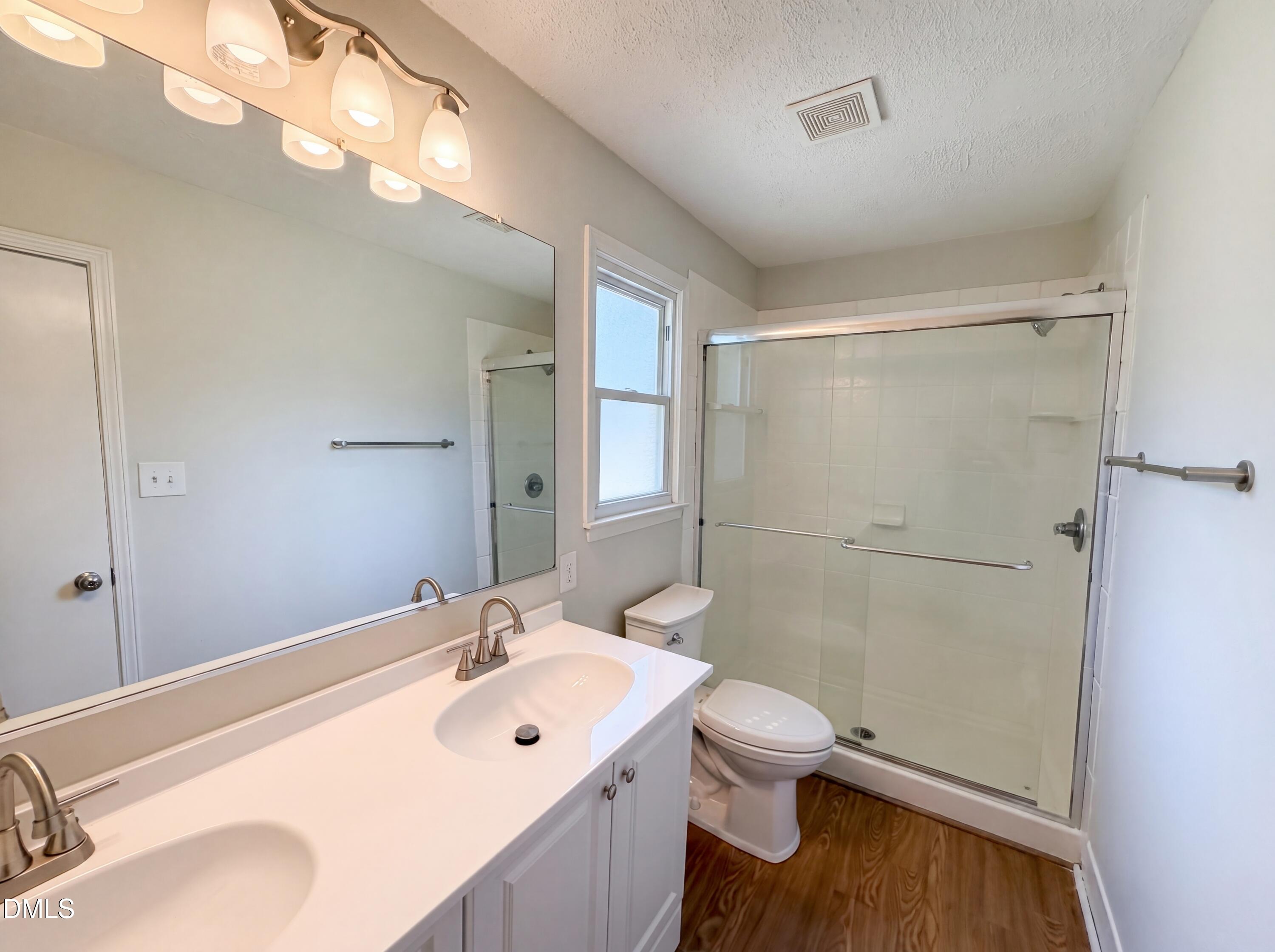 1710 West B Street Butner, NC 27509 - Photo 9 of 14 a bathroom with a sink a toilet and shower