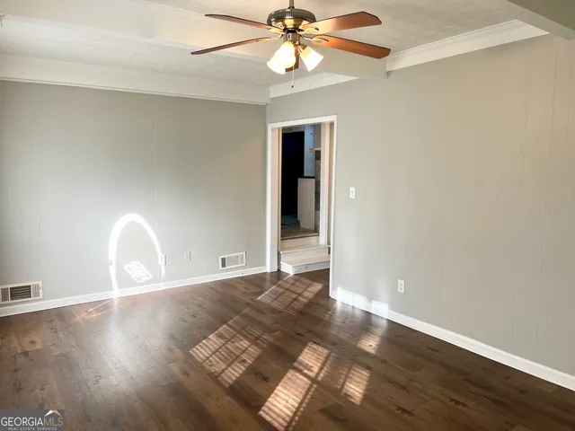 wooden floor in an empty room with a window