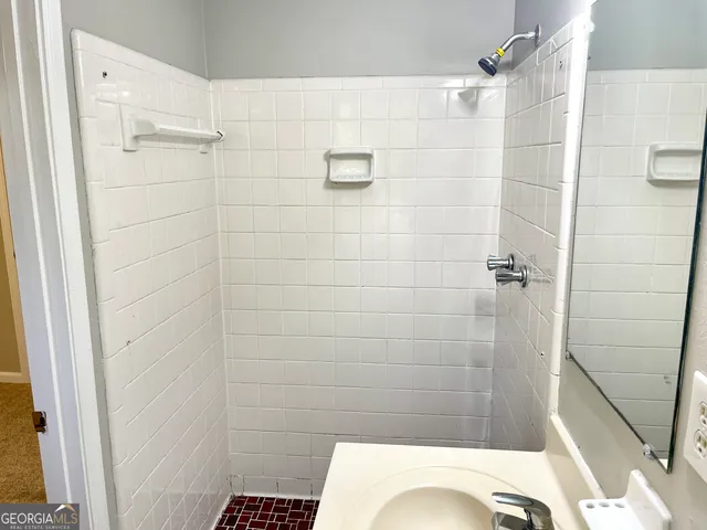 a bathroom with a toilet and shower