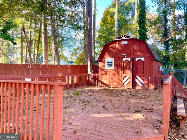 a view of a backyard with wooden fence