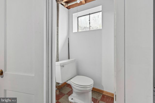 a white toilet sitting next to a shower