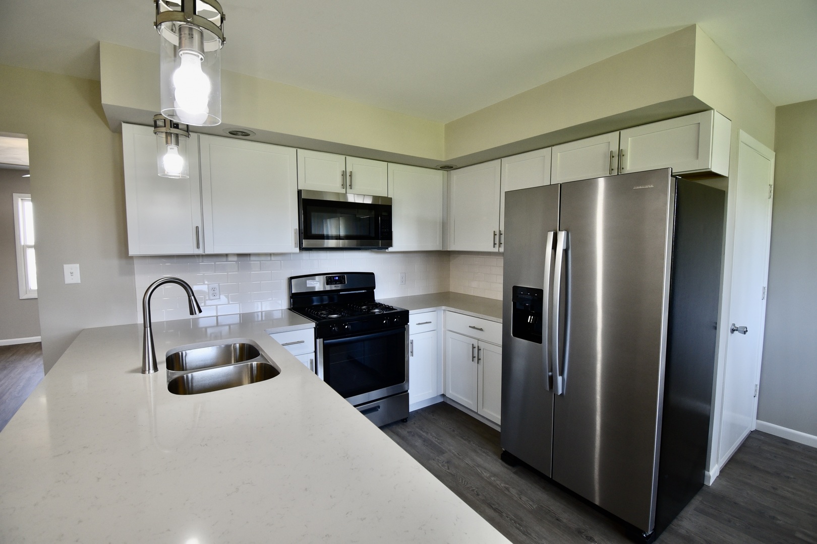 413 East Northtown Road North Normal, IL 61761 - Photo 14 of 20 a kitchen with stainless steel appliances granite countertop a refrigerator a stove and a sink with wooden floor