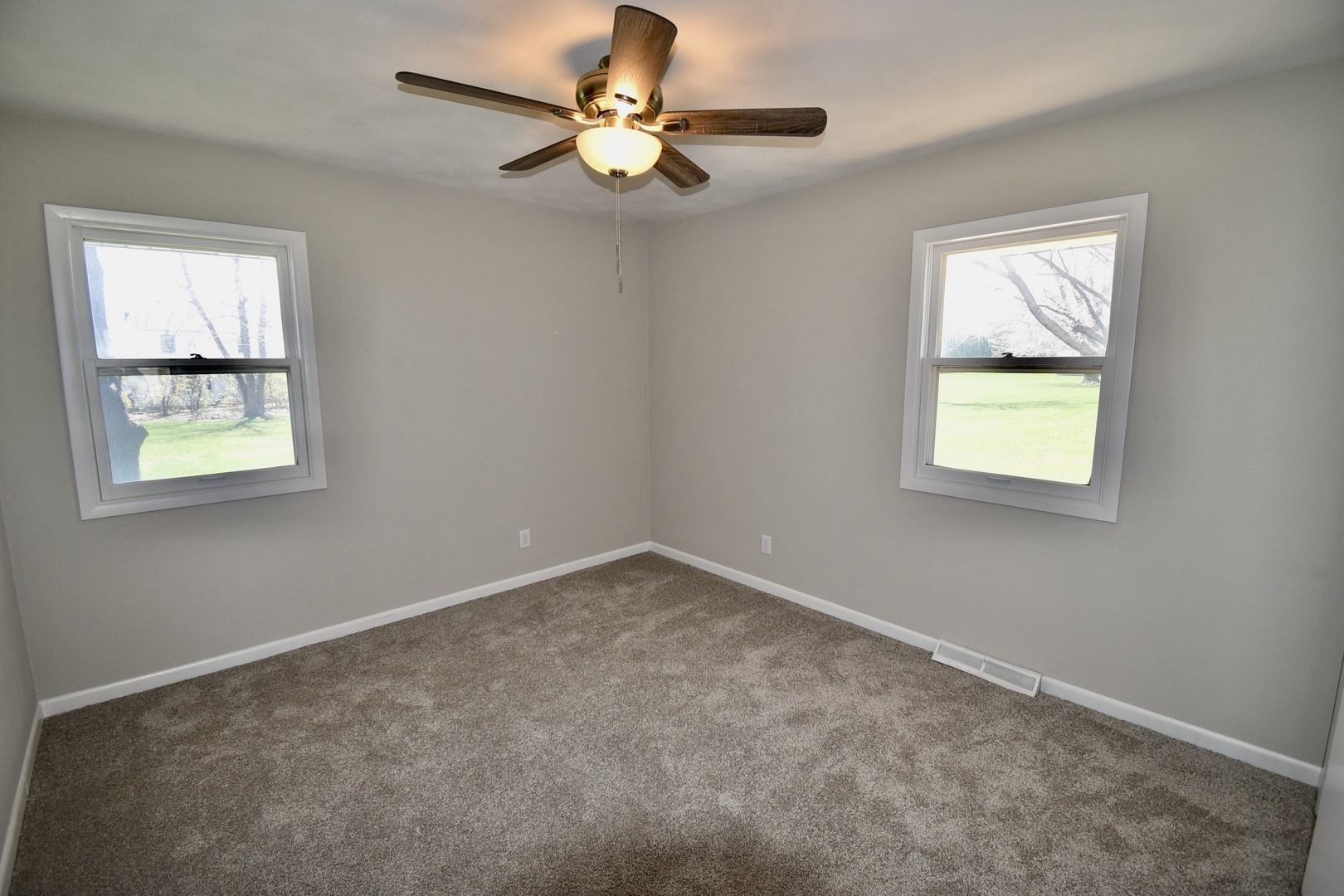 413 East Northtown Road North Normal, IL 61761 - Photo 17 of 20 an empty room with windows and fan