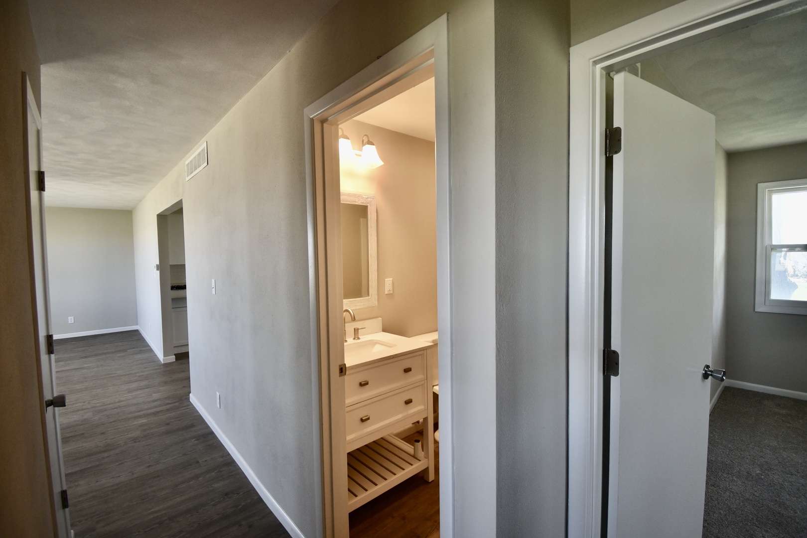 413 East Northtown Road North Normal, IL 61761 - Photo 19 of 20 a view of a hallway with wooden floor and a bathroom