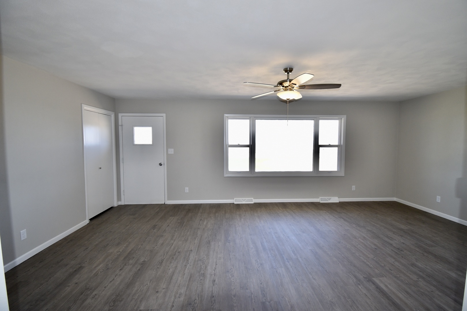 413 East Northtown Road North Normal, IL 61761 - Photo 6 of 20 an empty room with wooden floor ceiling fan with window