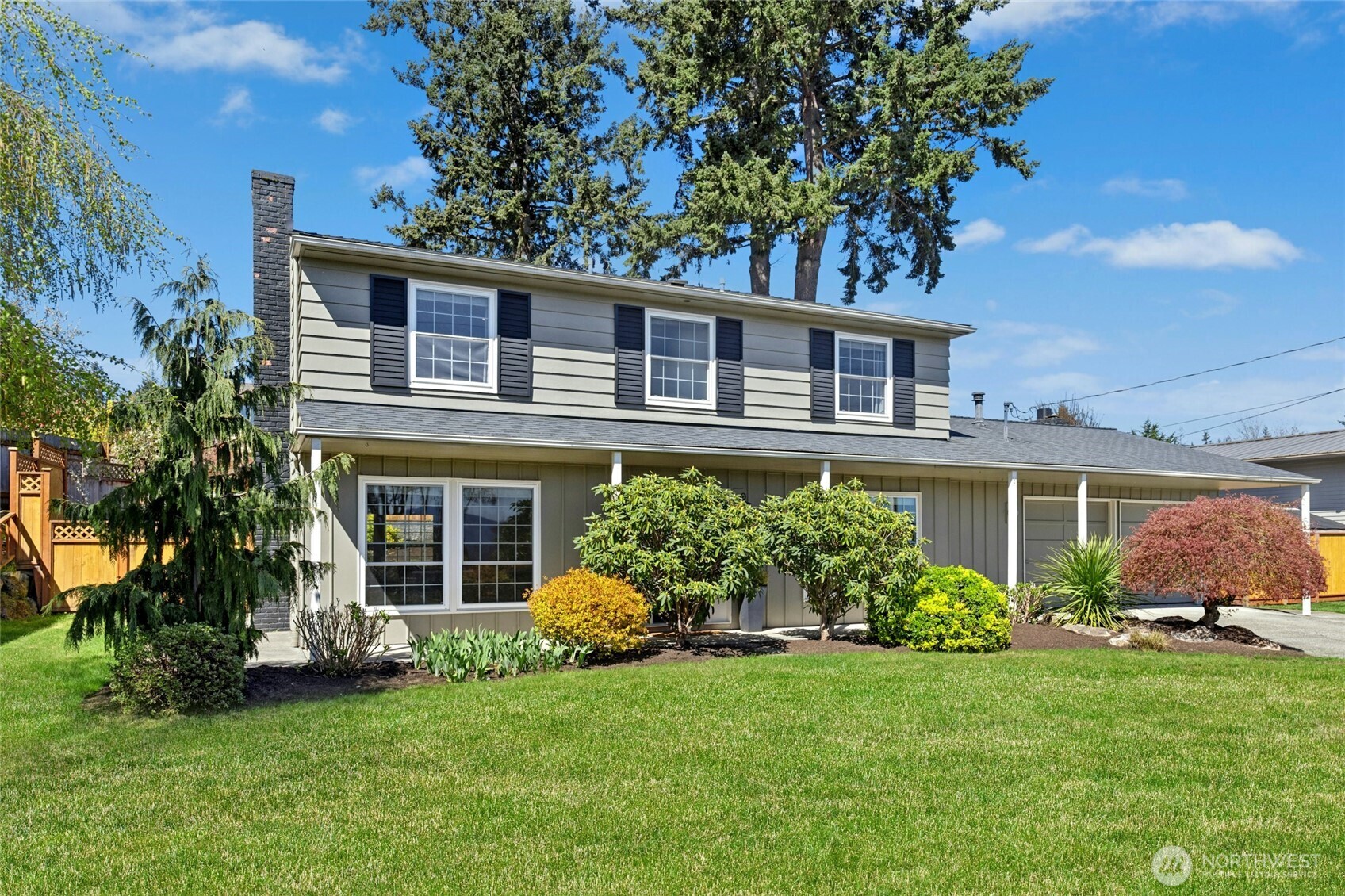 17154 Northeast 5th Street Bellevue, WA 98008 - Photo 1 of 40 a front view of a house with a yard