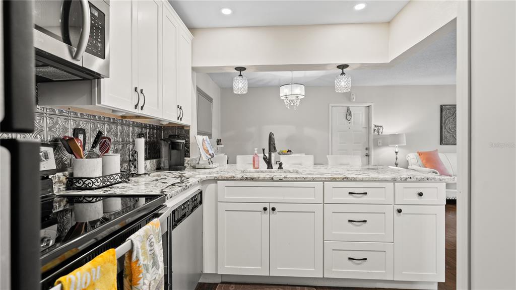 8203 Sun Spring Circle, Unit 12 Orlando, FL 32825 - Photo 24 of 38 a kitchen with white cabinets and appliances