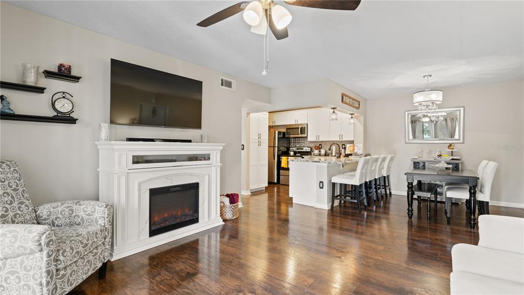 8203 Sun Spring Circle, Unit 12 Orlando, FL 32825 - Photo 25 of 38 a living room with furniture a fireplace and a flat screen tv