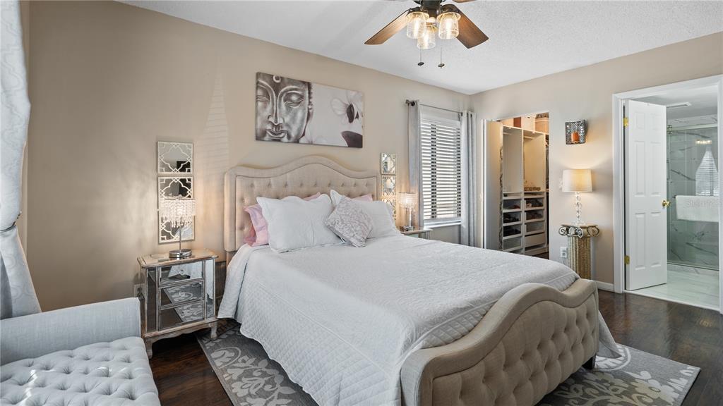 8203 Sun Spring Circle, Unit 12 Orlando, FL 32825 - Photo 27 of 38 a bedroom with a bed and a chandelier