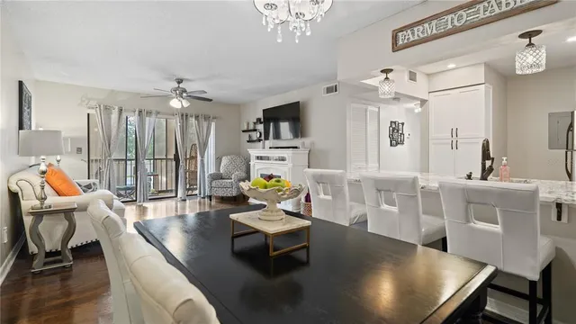 a living room with furniture a chandelier and a flat screen tv