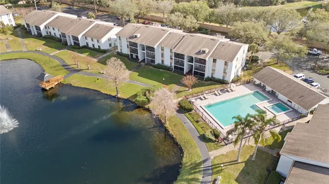 an aerial view of a house with swimming pool and outdoor space