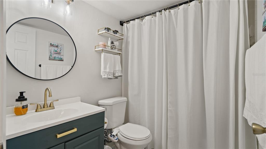 8203 Sun Spring Circle, Unit 12 Orlando, FL 32825 - Photo 8 of 38 a bathroom with a sink a mirror a toilet and a mirror