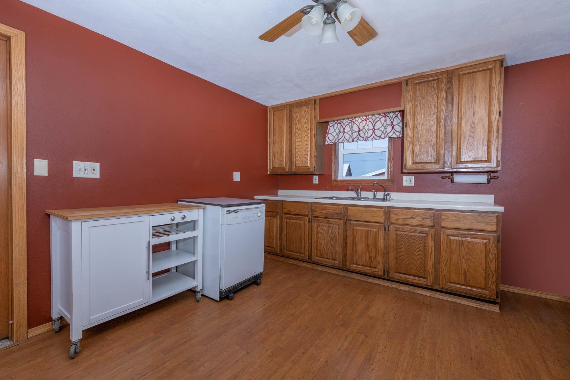 4868 Garden Prairie Road Belvidere, IL 61008 - Photo 11 of 36 a kitchen with a sink cabinets and window