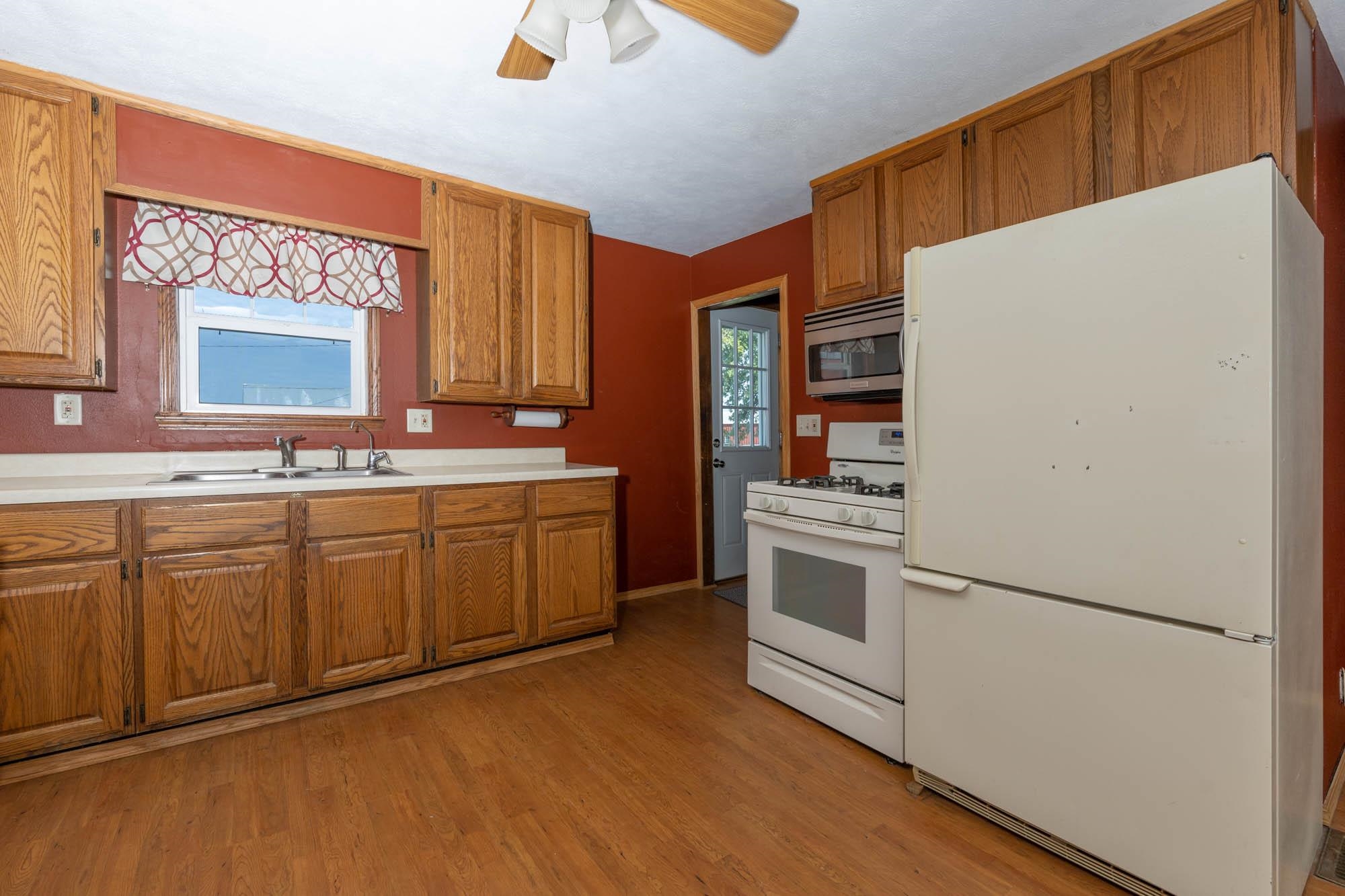4868 Garden Prairie Road Belvidere, IL 61008 - Photo 12 of 36 a kitchen with stainless steel appliances a refrigerator sink and cabinets