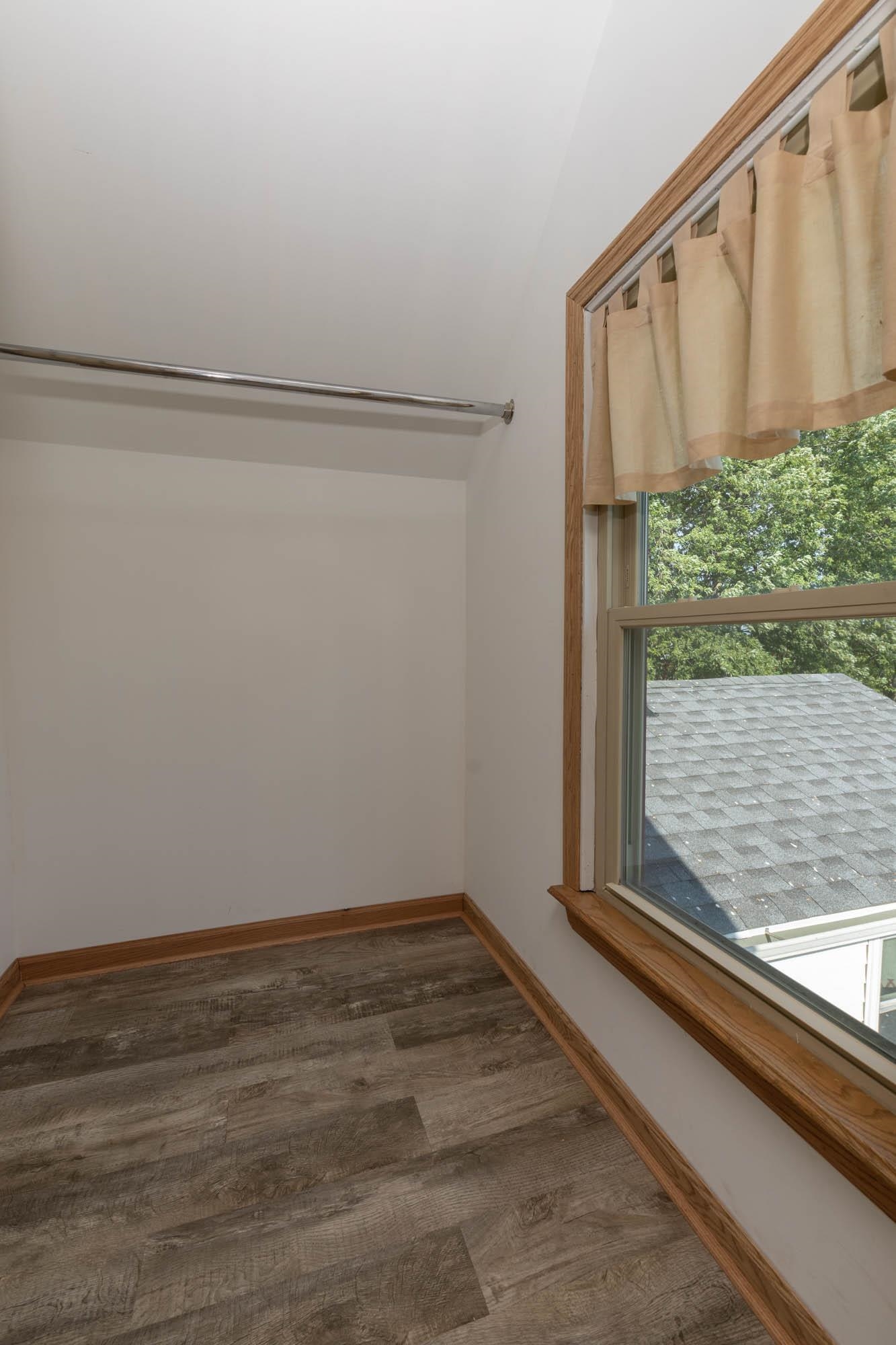4868 Garden Prairie Road Belvidere, IL 61008 - Photo 25 of 36 a view of a closet area with wooden floor