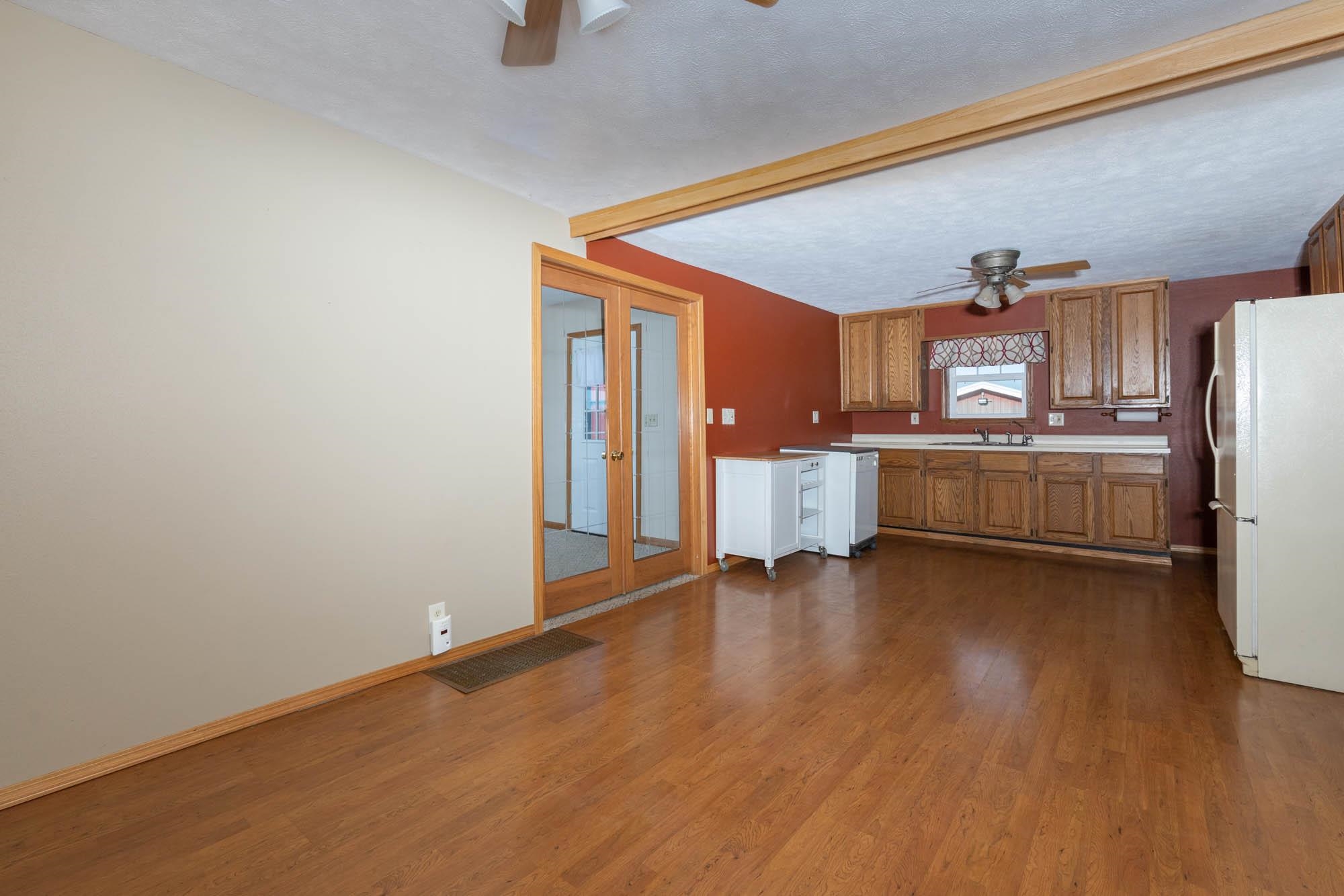 4868 Garden Prairie Road Belvidere, IL 61008 - Photo 9 of 36 a view of kitchen with stainless steel appliances wooden floor and chair