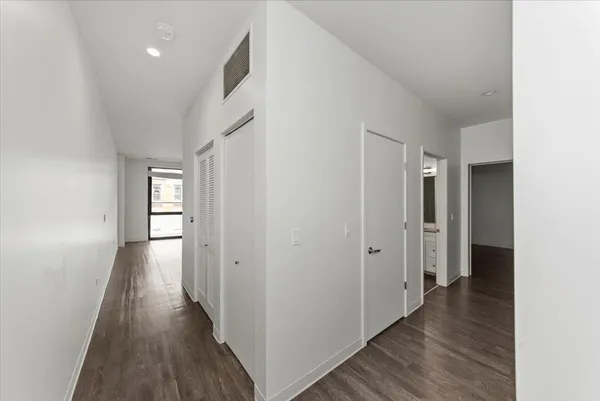 a view of hallway with wooden floor