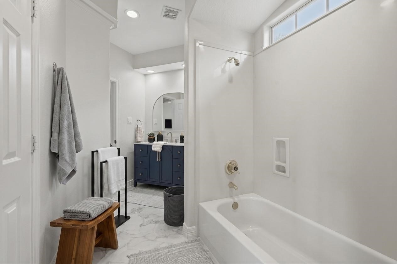 3315 Riviera Drive Sugar Land, TX 77479 - Photo 31 of 42 a bathroom with a tub sink and mirror