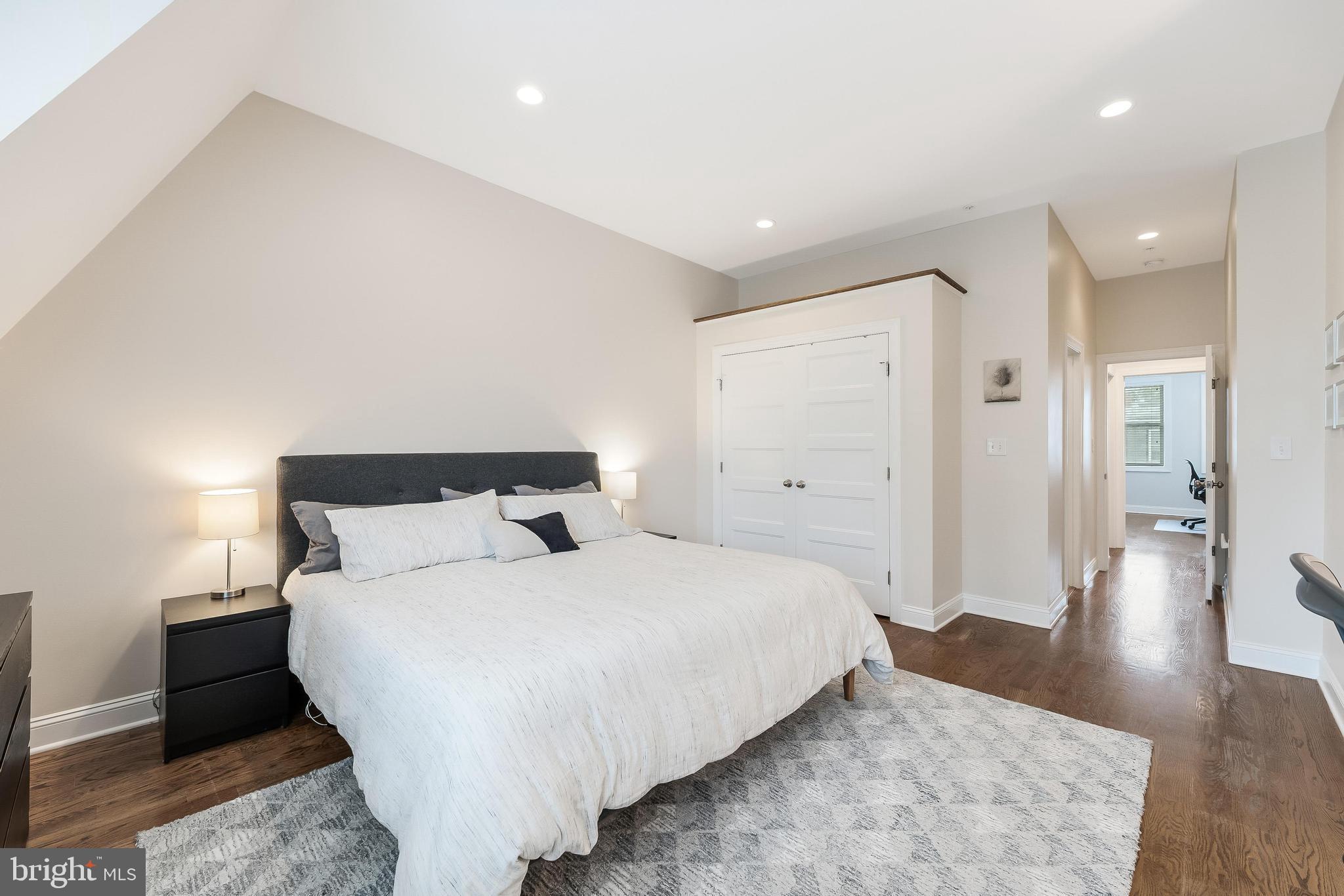 1613 Isherwood Street Northeast, Unit 3 Washington, DC 20002 - Photo 13 of 23 a bedroom with a bed and wooden floor