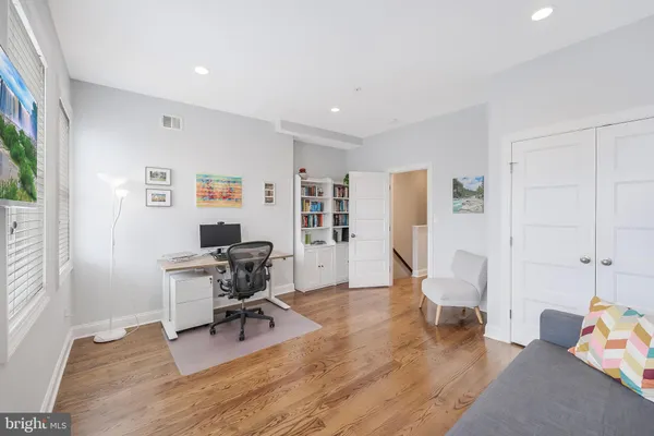 a view of a livingroom with workspace and a couch
