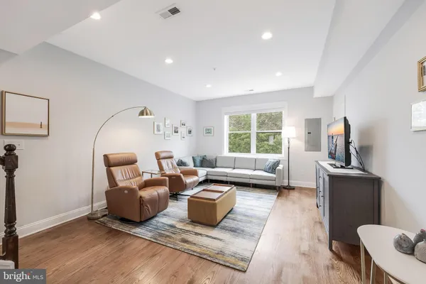a living room with furniture rug and window