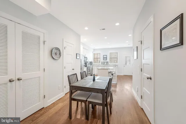 a view of a dining room with furniture and wooden floor