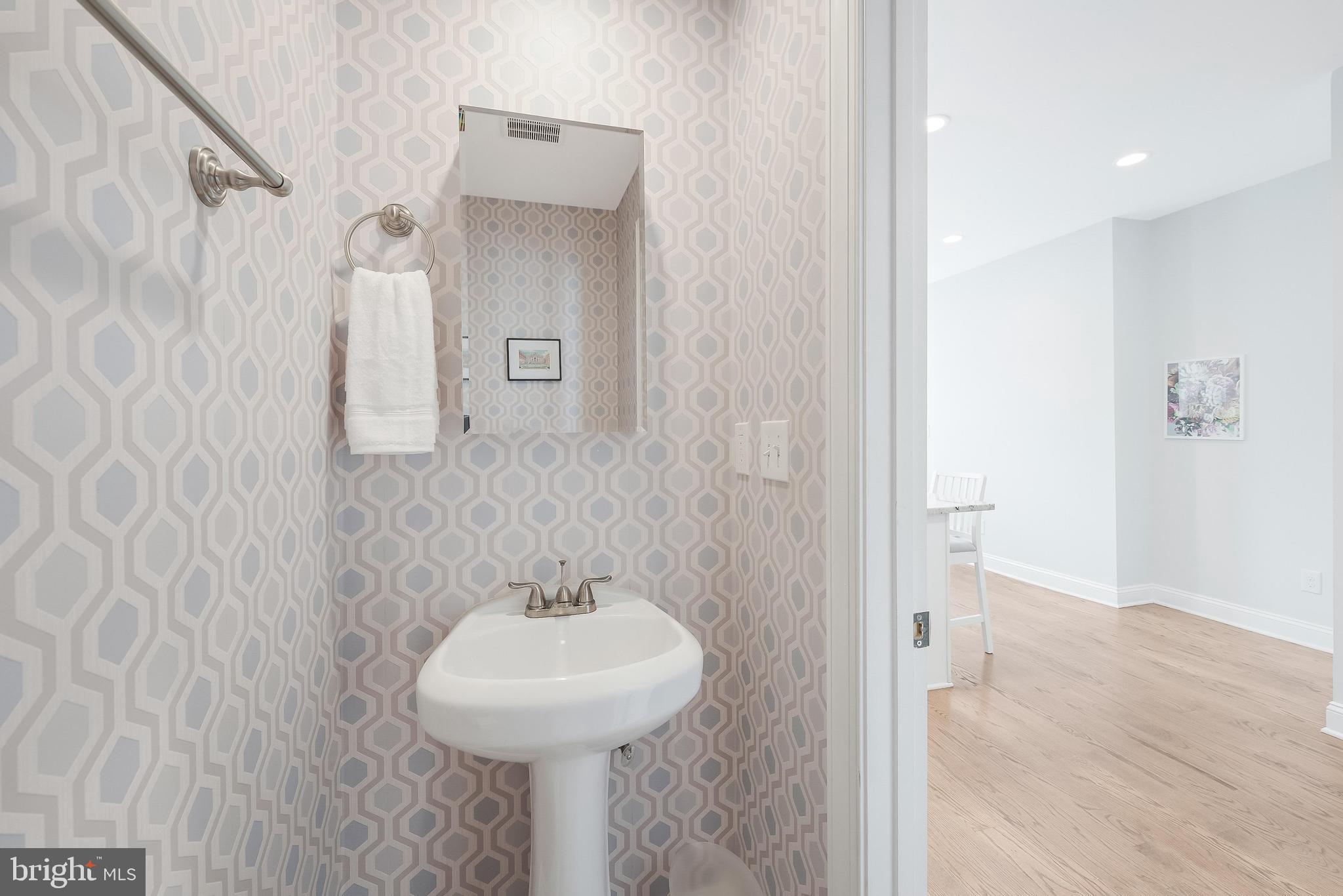 1613 Isherwood Street Northeast, Unit 3 Washington, DC 20002 - Photo 10 of 23 a bathroom with a sink a toilet and shower